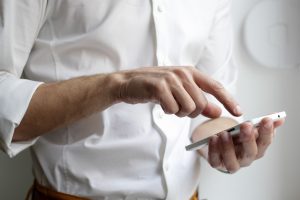 picture of man with a mobile representing Salestracker and customer data software